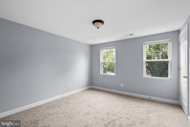 spare room with light colored carpet