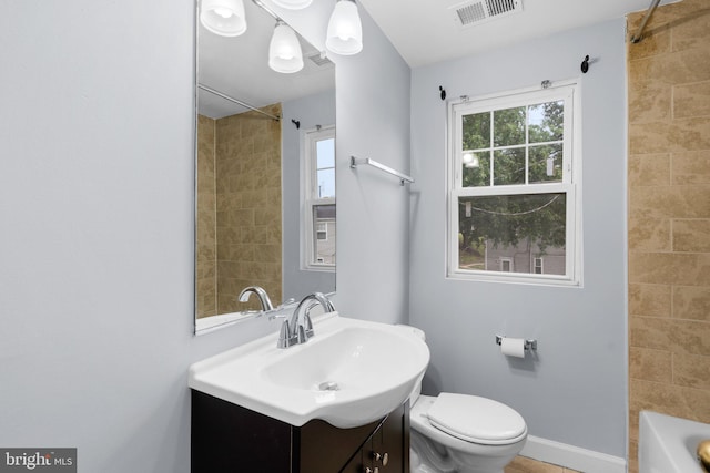 full bathroom featuring vanity, toilet, and tiled shower / bath