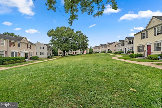 view of home's community with a yard