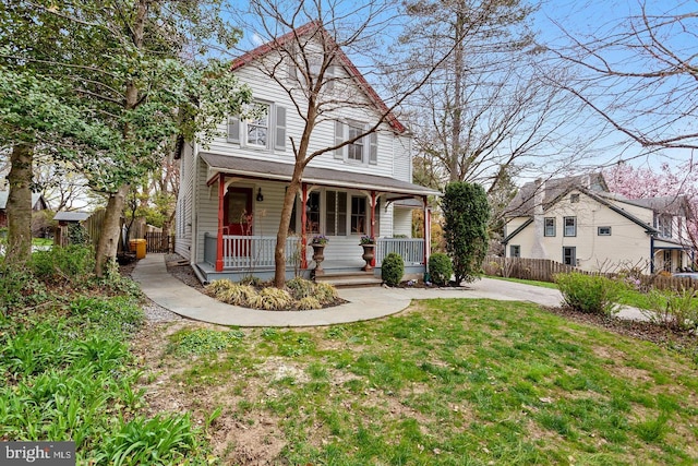 front facade with covered porch and a front lawn