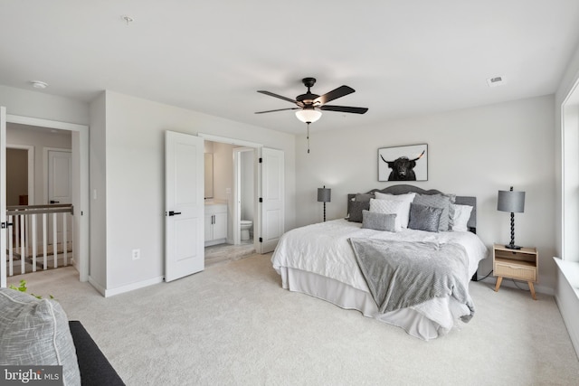 carpeted bedroom featuring ceiling fan and connected bathroom