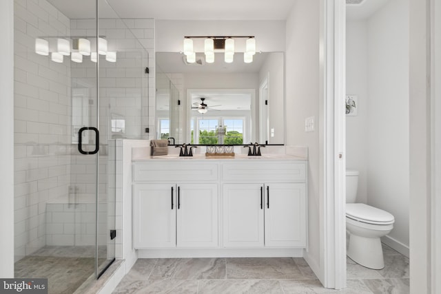 bathroom featuring ceiling fan, vanity, an enclosed shower, and toilet