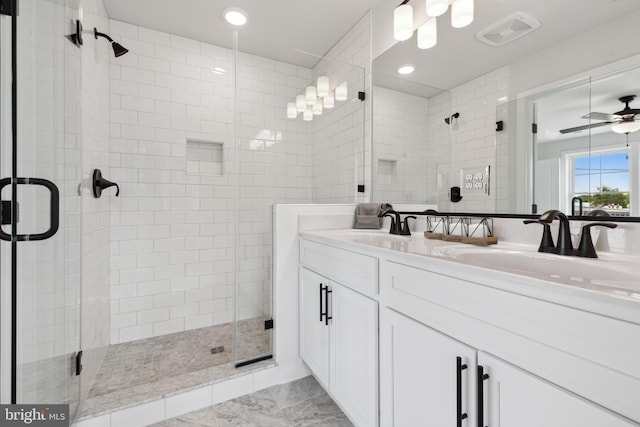 bathroom with walk in shower, vanity, and ceiling fan