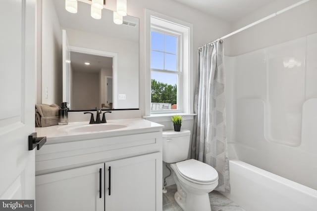 full bathroom with vanity, shower / tub combo, and toilet