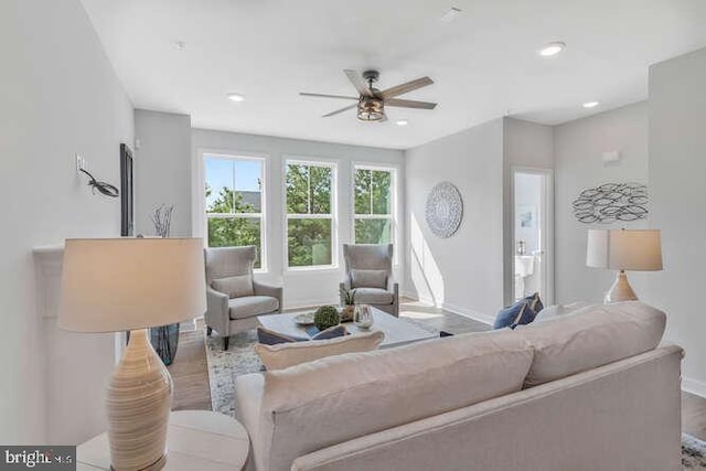 living room featuring ceiling fan and light wood-type flooring