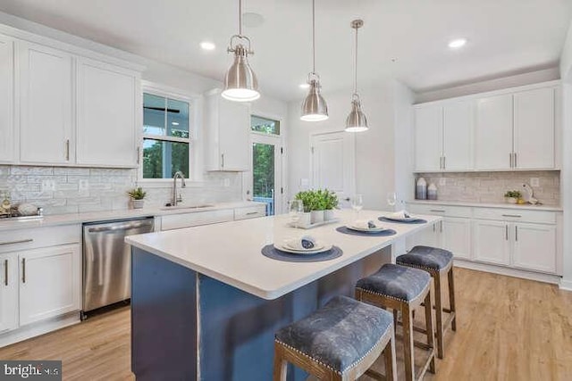 kitchen featuring dishwasher, white cabinetry, and sink