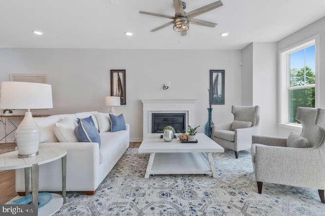 living room with light wood-type flooring and ceiling fan