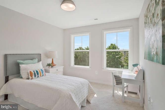 bedroom featuring light carpet