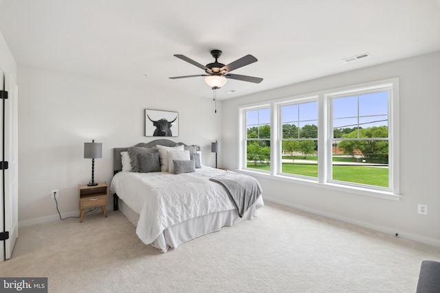 bedroom with light carpet and ceiling fan