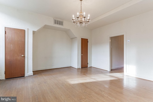 interior space with a chandelier and light hardwood / wood-style floors