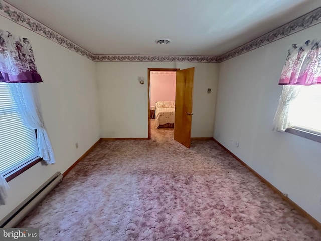 unfurnished bedroom with carpet and a baseboard radiator