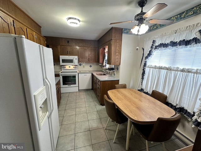 kitchen with sink, white appliances, ceiling fan, and light tile patterned flooring