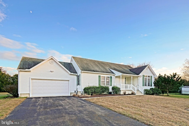 ranch-style house with a porch, a garage, and a front lawn