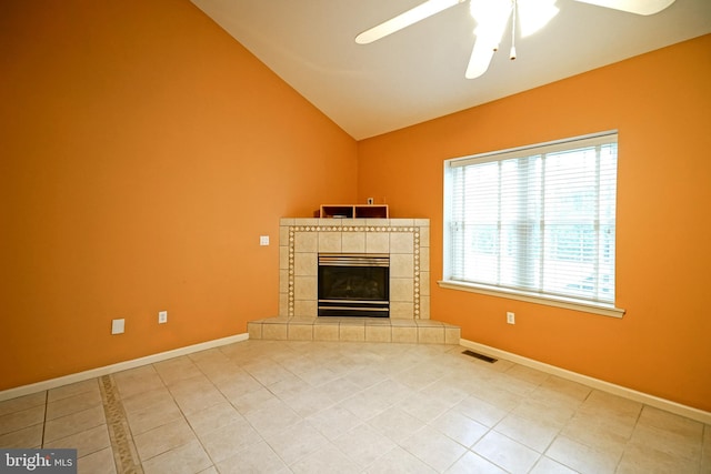 unfurnished living room with tile patterned floors, a tile fireplace, ceiling fan, and vaulted ceiling