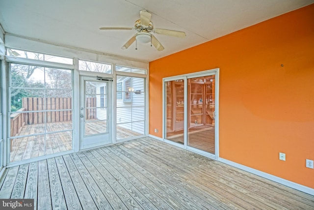 unfurnished sunroom featuring ceiling fan