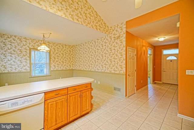 kitchen featuring decorative light fixtures, white dishwasher, and light tile patterned flooring