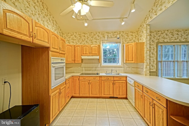 kitchen with white appliances, lofted ceiling, sink, ceiling fan, and light tile patterned floors