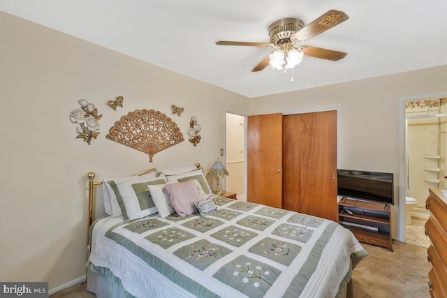 carpeted bedroom with connected bathroom, ceiling fan, and a closet