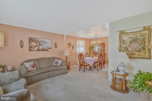 living room with a notable chandelier and carpet floors