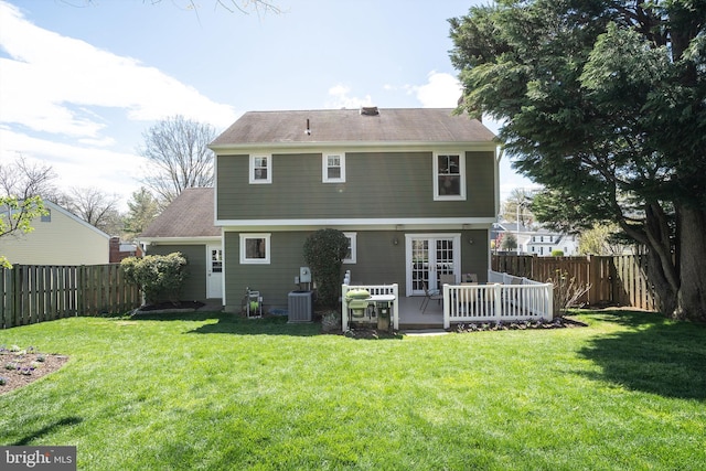 back of house with a wooden deck, central AC unit, and a lawn