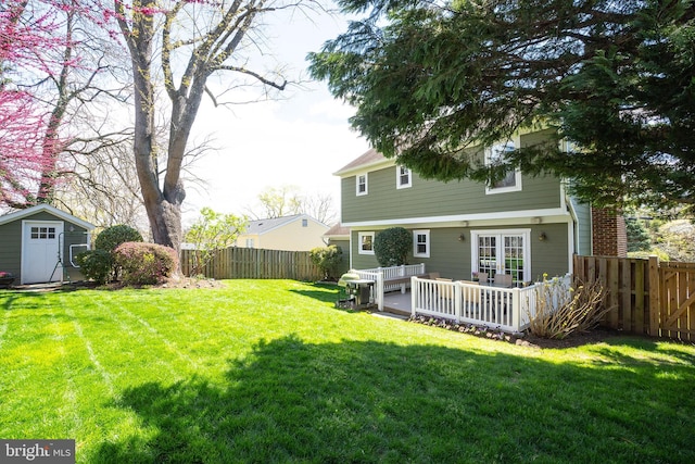 view of yard with a deck and a storage shed