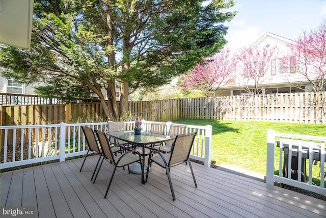 wooden terrace with a yard