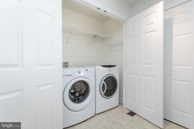 clothes washing area with independent washer and dryer