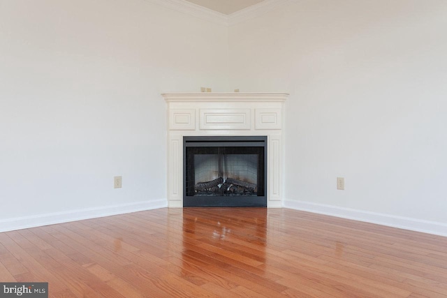 unfurnished living room featuring light hardwood / wood-style floors and ornamental molding