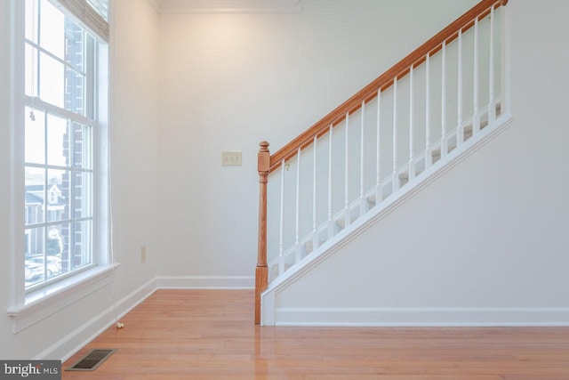 stairway featuring hardwood / wood-style floors and a wealth of natural light