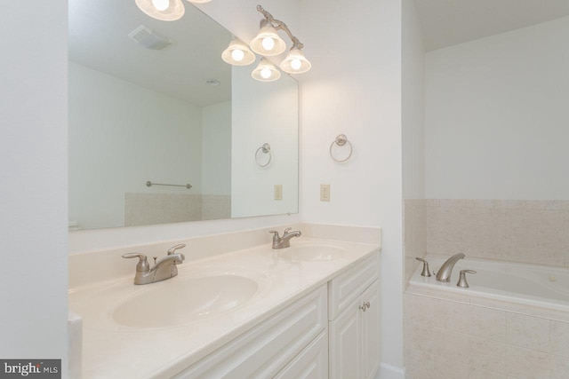 bathroom featuring vanity and tiled bath