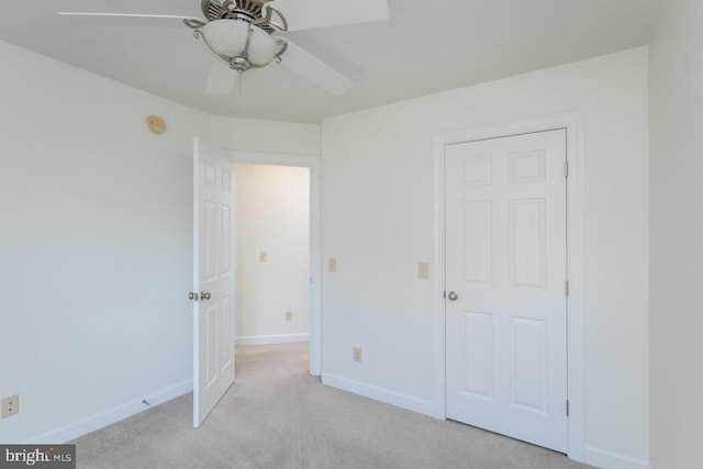 unfurnished bedroom featuring light carpet, a closet, and ceiling fan