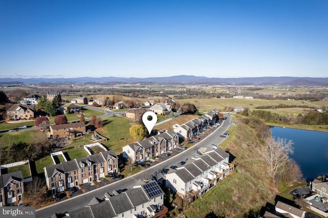 drone / aerial view featuring a water and mountain view