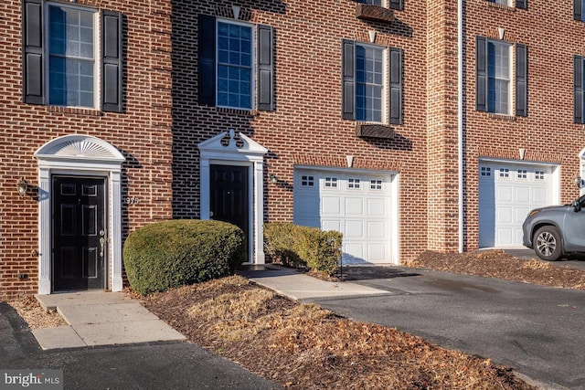 multi unit property featuring a garage