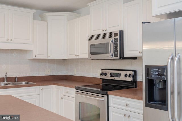 kitchen with white cabinets, stainless steel appliances, and sink