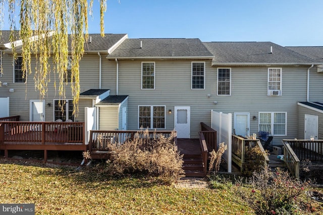 rear view of property with a wooden deck