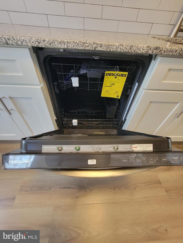 details with black dishwasher and white cabinetry