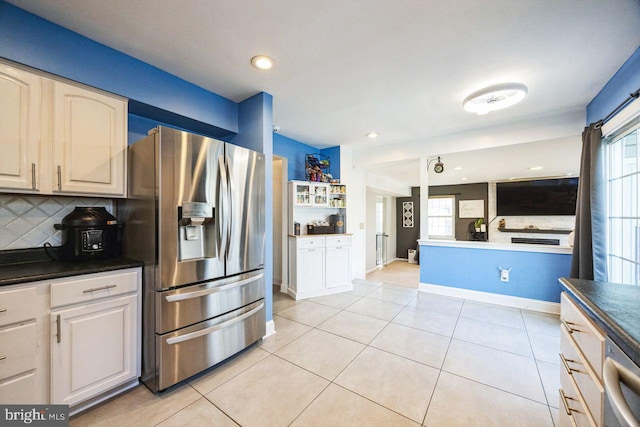 kitchen with light tile patterned floors, stainless steel appliances, and tasteful backsplash