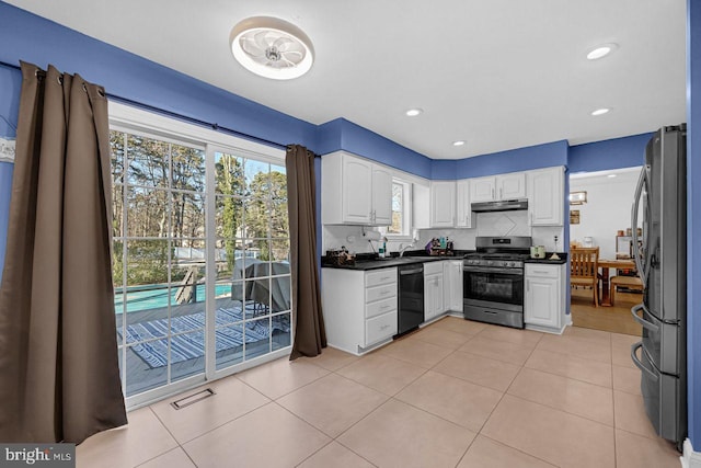 kitchen featuring white cabinets, decorative backsplash, stainless steel appliances, and a healthy amount of sunlight