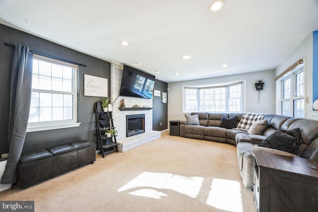 living room with light colored carpet and a brick fireplace