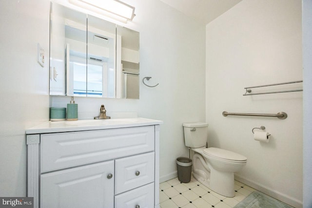 bathroom with tile patterned floors, vanity, and toilet