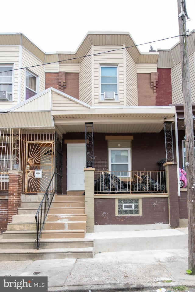 multi unit property featuring a porch and cooling unit