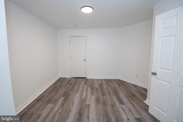 unfurnished room featuring dark hardwood / wood-style flooring