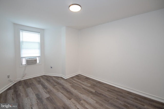 unfurnished room featuring dark hardwood / wood-style floors and cooling unit