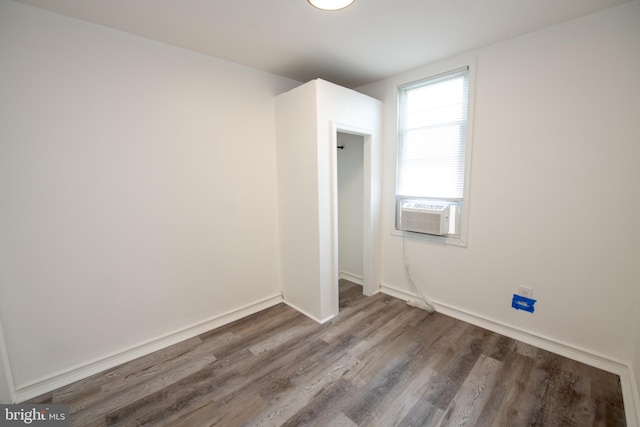 empty room with hardwood / wood-style flooring and cooling unit