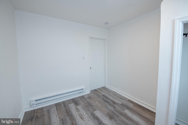 spare room featuring light hardwood / wood-style flooring and a baseboard radiator