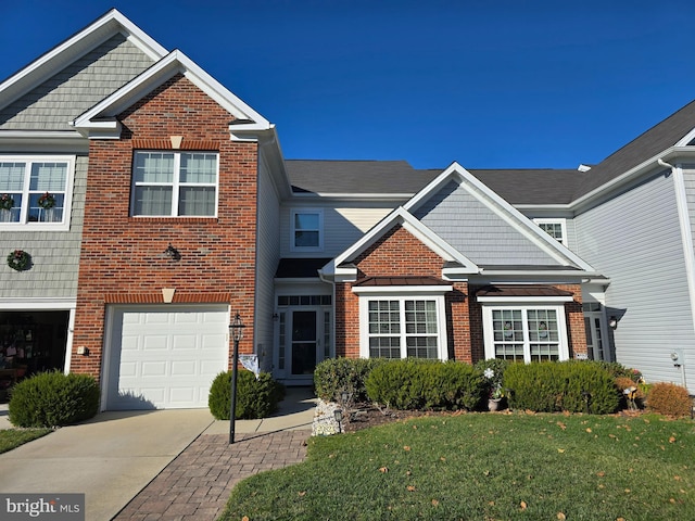 view of front of home featuring a garage and a front lawn