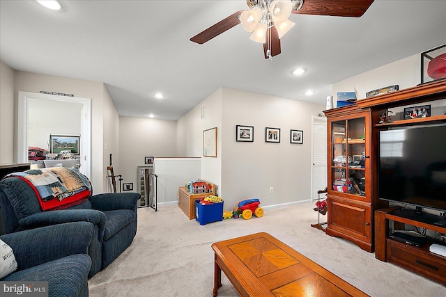 living room with ceiling fan and light colored carpet