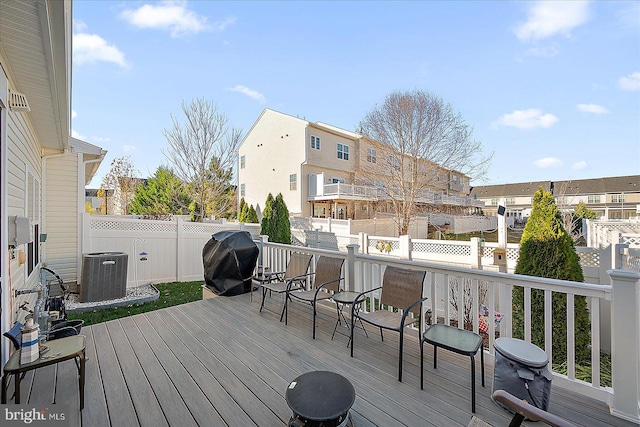 wooden terrace with grilling area and central air condition unit