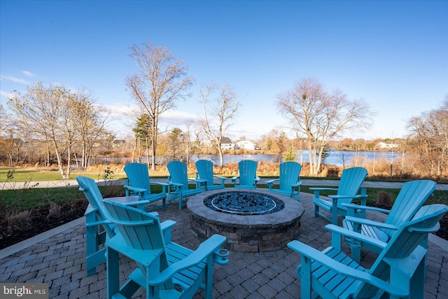 view of patio featuring a water view and a fire pit