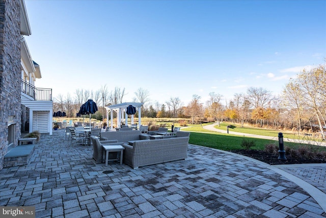 view of patio with outdoor lounge area and a balcony